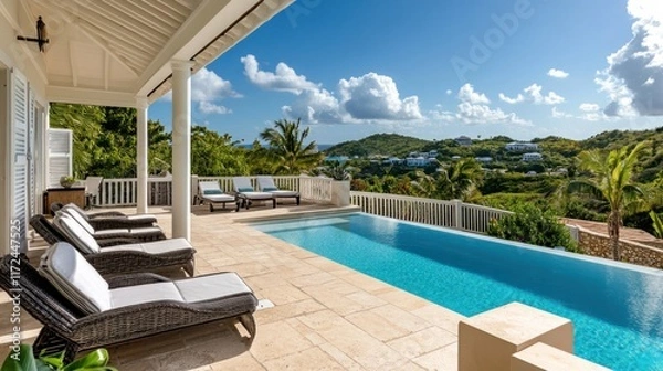 Obraz A picturesque villa terrace featuring a sparkling pool and panoramic views of a tropical island landscape