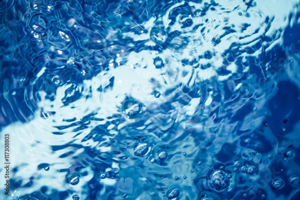 Fototapeta clear blue water with bubbles and ripples in swimming pool