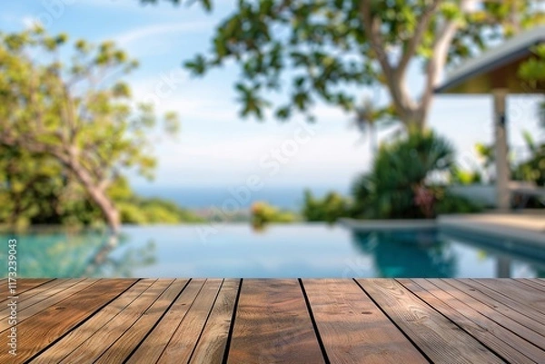 Fototapeta Relaxing view of a wooden deck overlooking a tranquil pool and lush greenery. Perfect for summer vibes.