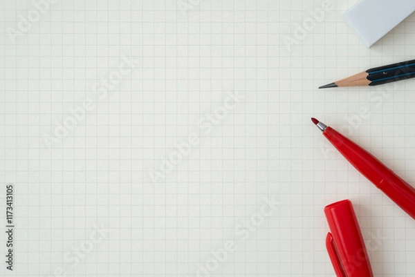 Fototapeta Top view, Close-up of Red Felt-tip Pen, Pencil and Eraser on Graph Paper, Copy Space for Text, Flat Lay Concept.