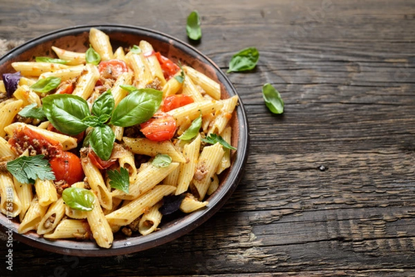 Fototapeta pasta with meat and basil on a plate on a wooden background
