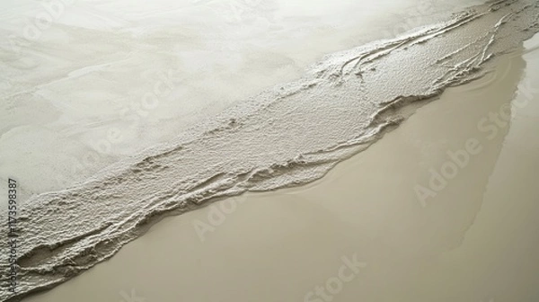 Fototapeta Fresh concrete pouring onto smooth surface creating textured pattern.