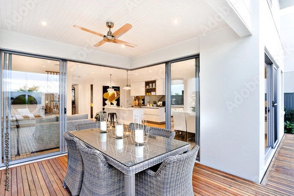 Fototapeta Outdoor patio area with table set up beside an entrance