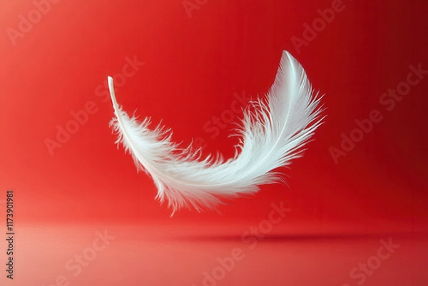 Fototapeta White feather flying on red background. Abstract bird feather falling on color background. Symbol of peace or freedom concept. Generated AI