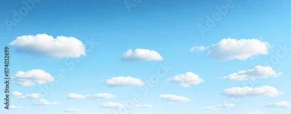 Fototapeta Concept for International Day of Clean Air for Blue Skies: A serene image of white cotton-like clouds set against the backdrop of a clear, blue sky