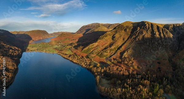 Fototapeta Dramatic aerial drone landscape in Autumn Winter of snowcapped mountains around Buttermere in Lake District at sunrise