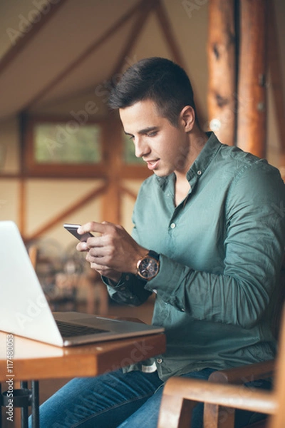 Obraz Young man using mobile phone