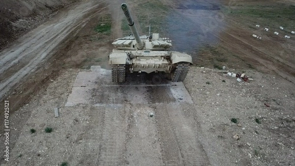 Fototapeta drone view - heavy tank climbs over walls