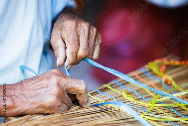 Fototapeta Old Man’s Hand Crafting a Traditional "Vouve" Tool for Catching Bichique