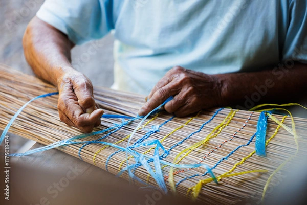 Fototapeta Old Man’s Hand Crafting a Traditional "Vouve" Tool for Catching Bichique