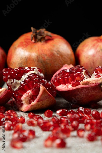 Fototapeta Ripe pomegranates, peeled and whole, the concept of benefits and vitamins in fruit.
