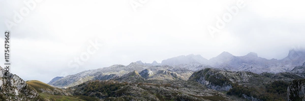 Obraz A view of the Picos de Europa National Park in Asturias, Spain. This photo was taken from the Lagos de Covadonga, by Lago de la Ercina. The sunlight is hitting the mountains as the clouds pass over.