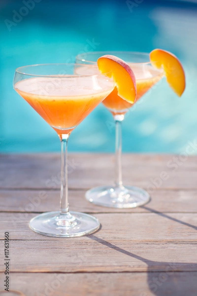 Fototapeta Bellini cocktail with peach isolated near pool