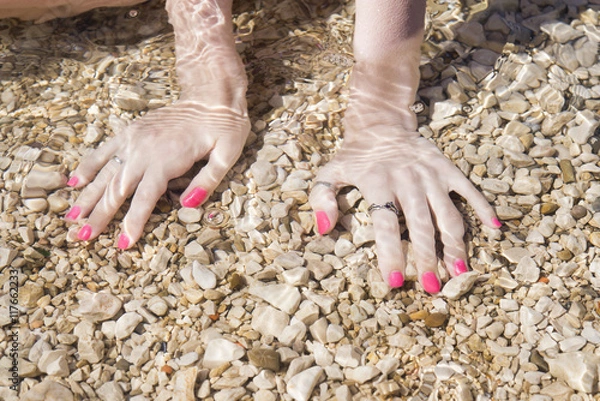 Obraz Hands with manicure under the sea water