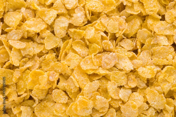 Fototapeta Yellow dry corn flakes background. Closeup. Top down view.