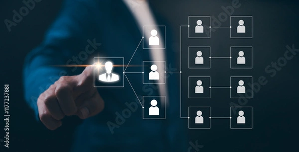 Obraz Businessman point a glowing digital organizational chart, leadership and team structure. Manager team management of company, networking in business hierarchy job concept, president job change control