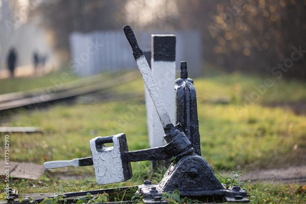 Fototapeta A freshly painted railroad track switching mechanism close up.