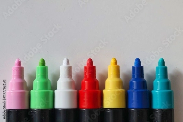 Obraz Colorful marker pens arranged in a row on a white background