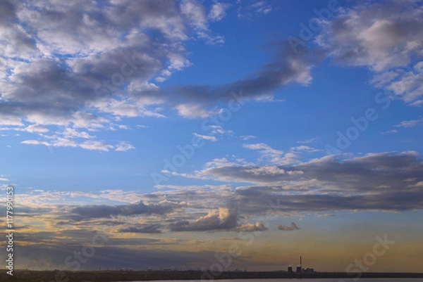 Obraz CHP and other plants stand on the shore of the lake in the evening at dusk under the evening sky