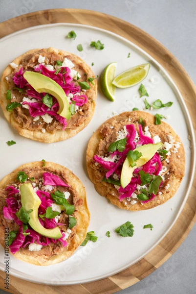 Obraz REFRIED BEAN AND PICKLED RED CABBAGE TOSTADAS with fresh cilantro, avocado and lime juice