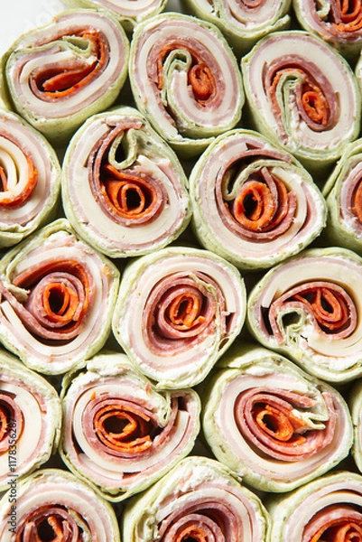 Obraz Italian Sub Pinwheels with pepperoni, salami, ham, provolone, mozzarella, cheese wraps for party appetizers