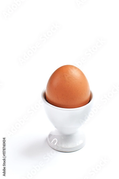 Fototapeta Whole boiled egg in egg cup