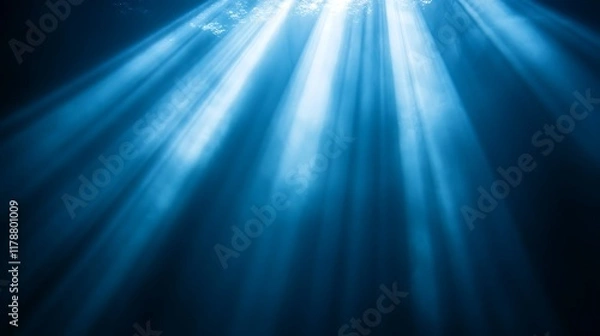 Obraz Underwater sunbeams, ocean depth, light rays, dark blue background, nature scene.