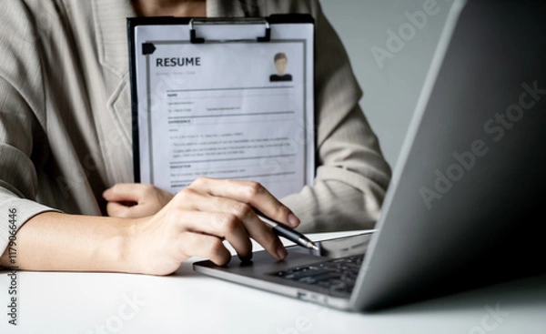 Fototapeta Executive CEO businesswoman checking job applicant documents resumes, interviews, and signing to approve the contract in the office room