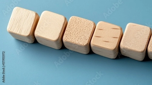 Fototapeta Wooden cubes on blue surface, smooth textures