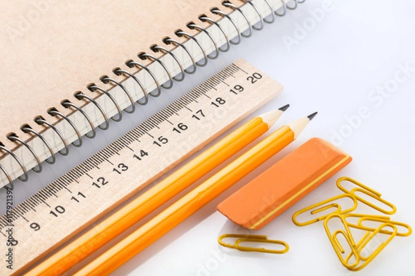 Fototapeta notebook, eraser, ruler, pencil and paperclips