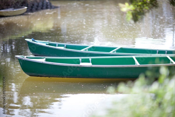 Obraz Pair of green canoes moored on a lake in Thailand