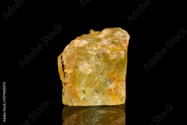 Fototapeta Natural rough golden beryl (beryl group) gemstone on dark background (selective focus)