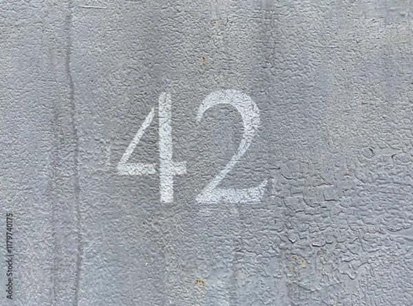 Obraz White number 42 on gray background. Forty two on textured surface 