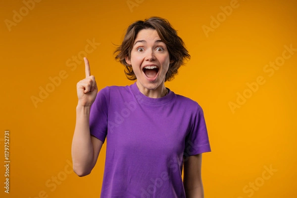 Obraz Breakthrough genius idea. Happy woman having eureka moment, pointing finger up on yellow background. Clever lady showing answer gesture or remembered what she forgot, memory concept