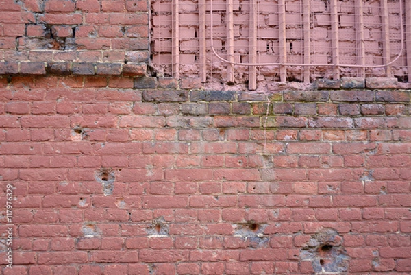 Fototapeta Brick wall with bullet marks