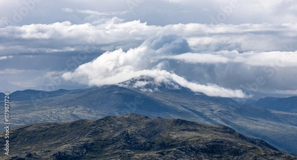 Fototapeta Radio-tower on Blåhøe partly covered by clouds -  seen from Formokampen in the Rondane national park