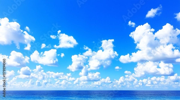 Fototapeta Azure Horizon:  A serene expanse of azure sky, adorned with cotton-candy clouds, seamlessly meets the tranquil expanse of the ocean.