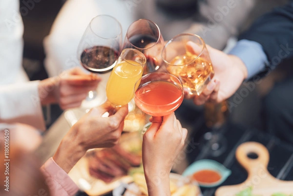 Obraz Cheers to Togetherness: A captivating overhead shot of friends raising a toast with diverse drinks, symbolizing unity and celebration during a festive gathering.  