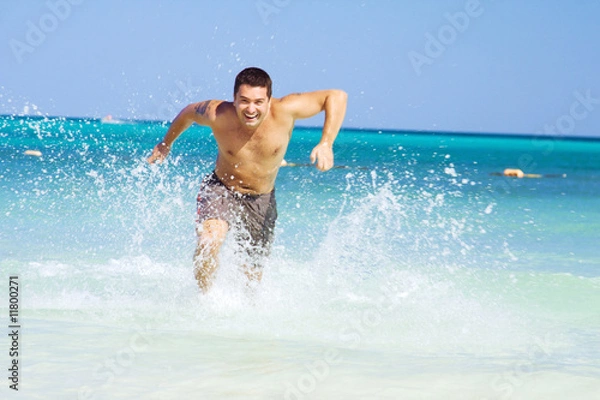 Fototapeta running out of the ocean