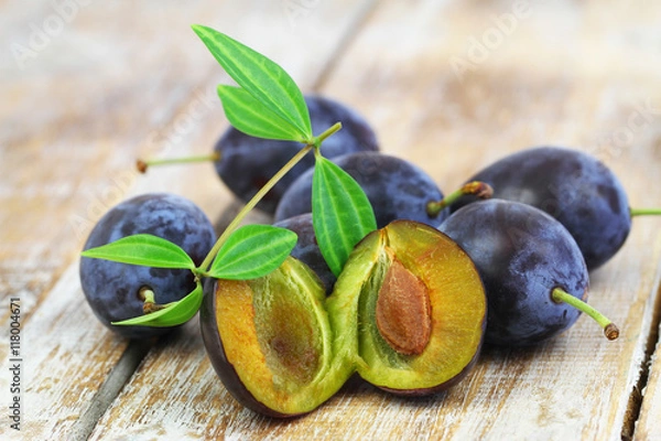 Obraz Few juicy plums on rustic wooden surface, closeup
