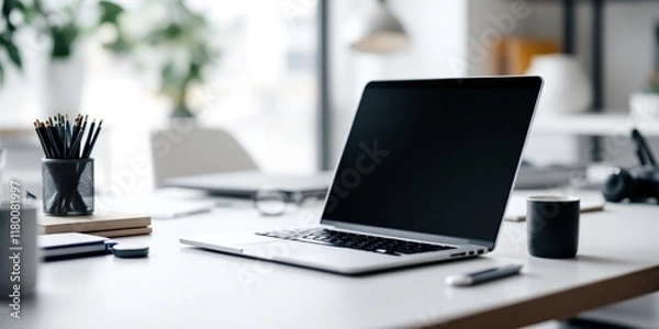 Fototapeta Modern workspace with laptop on desk. Bright home office setup with computer, stationery, and coffee cup. Clean and minimalist design for remote work, freelancing, or studying