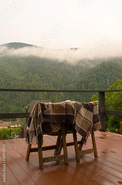 Obraz Wooden chairs with a blanket on the background of a mountain landscape, vacation in the mountains