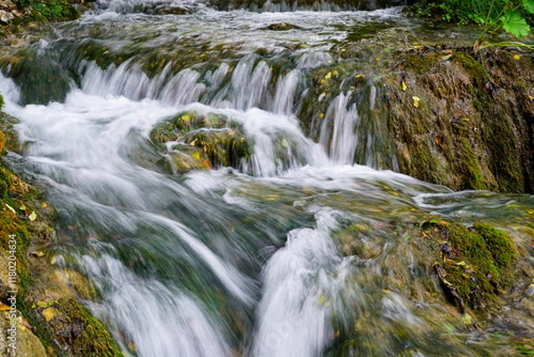 Fototapeta Low shutter speed shot of beautiful waterfall from hiking trail in Plitvice lakes national park