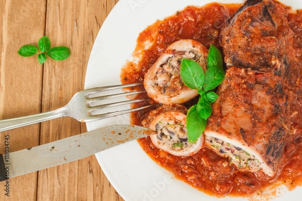 Fototapeta Stuffed squid with parmesan cheese, onion and parsley in tomato sauce.