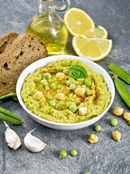 Obraz Hummus from green peas in bowl with bread on table