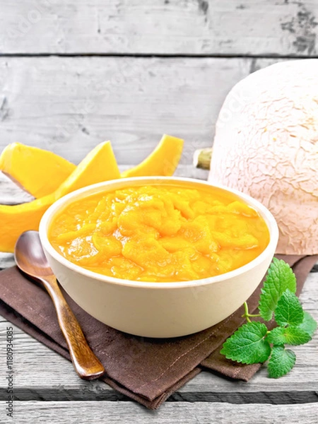 Obraz Pumpkin puree in bowl on wooden board