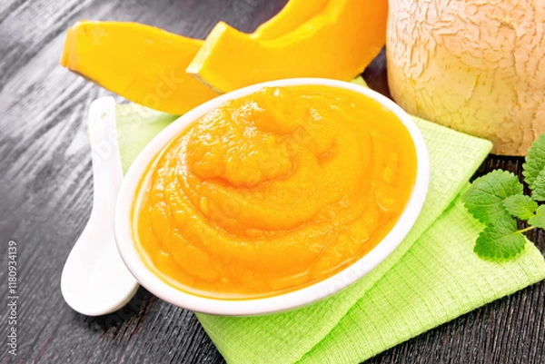 Obraz Pumpkin puree in plate on dark board