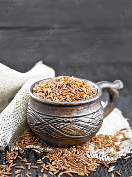 Obraz Rice red in cup on black board