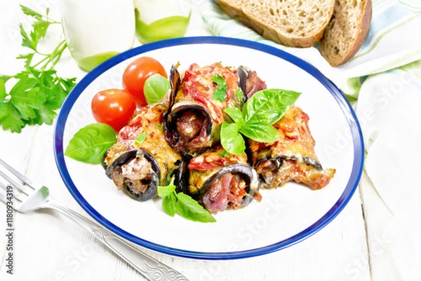 Obraz Rolls of eggplant with meat in plate on light board
