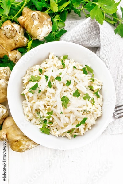 Obraz Salad of Jerusalem artichoke and eggs in plate on light board top